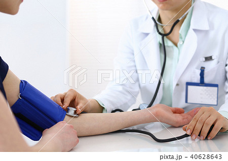 Doctor checking blood pressure of the patient, closeup. Cardiology in medicine  and health car 40628643