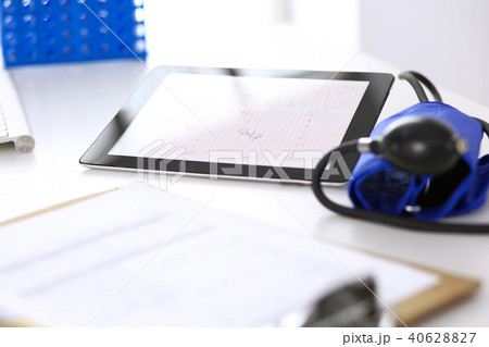 Workplace of doctor. Tablet ps showing heart diagrams closeup. Healthcare and  cardiology in medicin 40628827