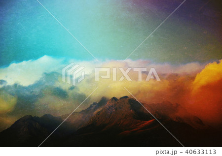 Clouds rolling over mountain peaks Clouds rolling over mountain peaks 40633113