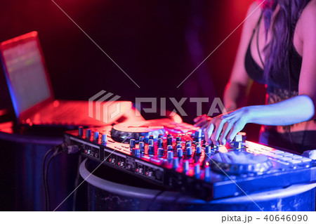 Motionblur of Dj hands on equipment deck and mixer 40646090
