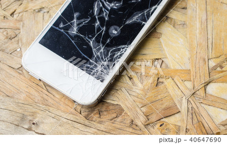 broken screen phone on wood table, with copy space 40647690