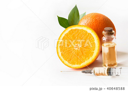Orange fruit and plastic disposable syringe. Orange fruit and plastic disposable syringe. 40648588
