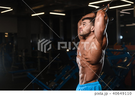 Handsome model muscle man abs workout in gym Handsome model muscle man abs workout in gym 40649110