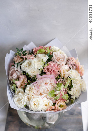 beautiful luxury bouquet of mixed flowers in woman hand. the work of the florist at a flower shop beautiful luxury bouquet of mixed flowers in woman hand. the work of the florist at a flower shop 40651751