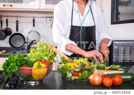 Young happiness Woman Cooking vegetables salad in the kitchen, H Young happiness Woman Cooking vegetables salad in the kitchen, H 40653606