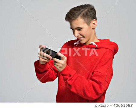 teenager playing games on smartphone teenager playing games on smartphone 40661062