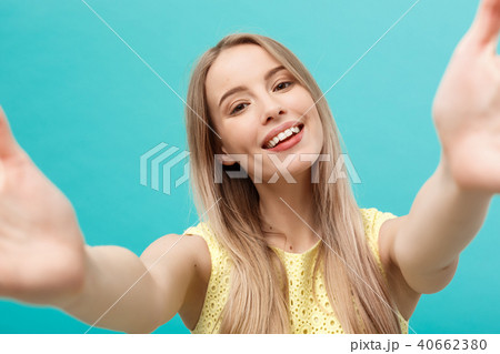 Close-up portrait of attractive young woman stretching her arms, wants to hug you. Isolated on blue Close-up portrait of attractive young woman stretching her arms, wants to hug you. Isolated on blue 40662380
