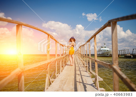 girl in a blue hat goes along the pier girl in a blue hat goes along the pier 40663983