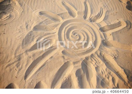 the sun is painted on the sand on a wonderful  40664450