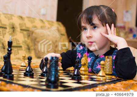 granddaughter plays chess with his grandfather. grandfather teaches to play 40664979
