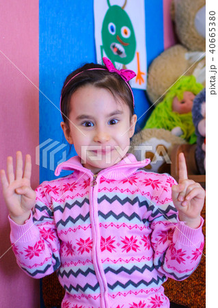 cute girl on the background of her toys smiling 40665380