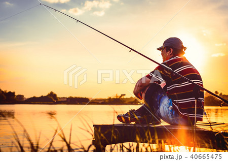 Fisherman caught fish. Caucasian man catch fish on lake. Angler on river fishing. fishing rod lake 40665475