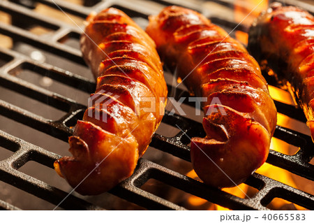 Grilling sausages on barbecue grill 40665583