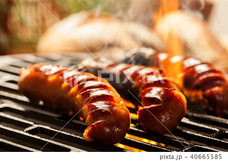 Grilling sausages on barbecue grill 40665585