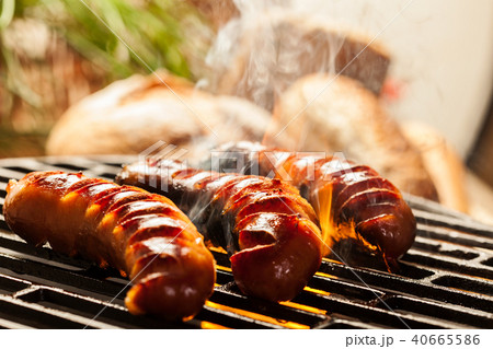 Grilling sausages on barbecue grill Grilling sausages on barbecue grill 40665586