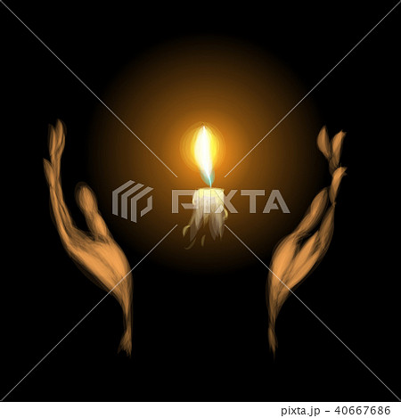 hands holding a burning candle in dark 40667686