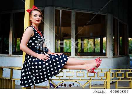 beautiful young woman posing in retro dress beautiful young woman posing in retro dress 40669395