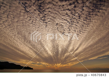 孔雀の羽のような雲とその先には天使の梯子が見られた駿河湾の空の写真素材