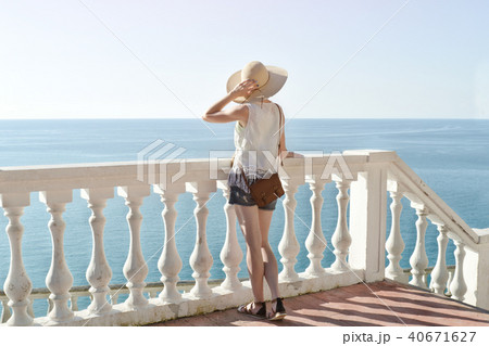 Girl in hat standing on the stairs and looking Girl in hat standing on the stairs and looking 40671627