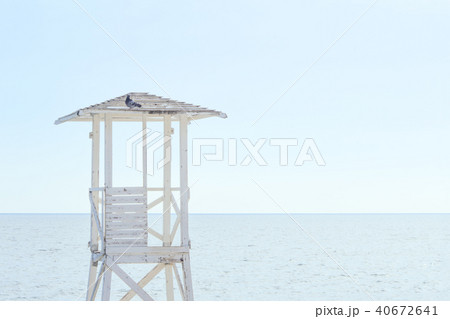 A white wooden lookout lifeguard tower. A white wooden lookout lifeguard tower. 40672641