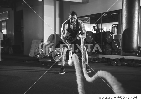 Men with rope in functional training gym Men with rope in functional training gym 40673704