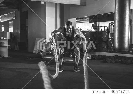 Men with rope in functional training gym Men with rope in functional training gym 40673713