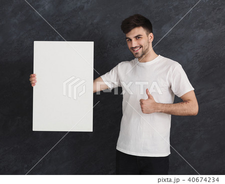 Young cheerful man with blank white paper 40674234