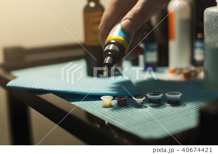 Tattoo ink poured into small caps 40674421