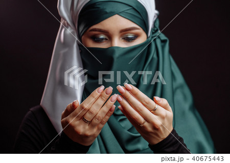 close up portrait of arabian female reading Koran. close up portrait of arabian female reading Koran. 40675443