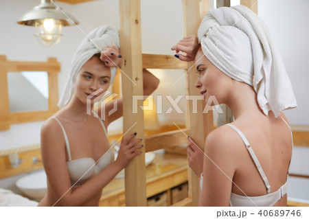 beautiful smiling young woman with a towel on her head after bat beautiful smiling young woman with a towel on her head after bat 40689746