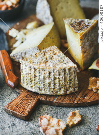 Cheese assortment on board, close-up, vertical composition 40690187