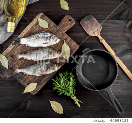 three river fish on a brown wooden board  40693121