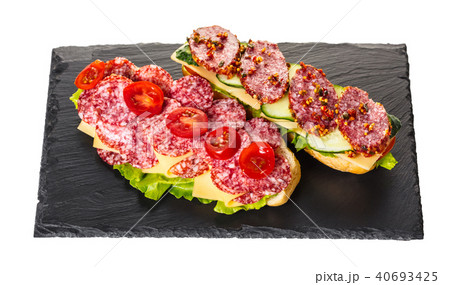 sandwich with salami, cheese and vegetables 40693425