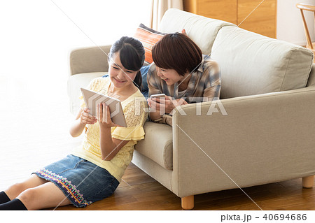 ソファーでタブレットを見る親子 40694686