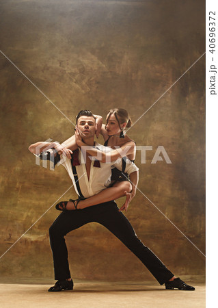 Flexible young modern dance couple posing in studio. 40696372