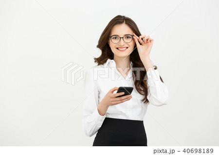 Business Concept: Portrait of Business woman wearing white shirt using a mobile phone isolated on a 40698189