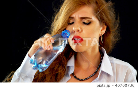 Sensitive teeth woman drinking cold water from bottle. Sudden toothache. Sensitive teeth woman drinking cold water from bottle. Sudden toothache. 40700736