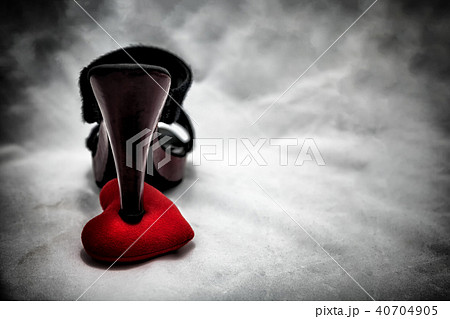 women shoes stomp on broken heart in dark tone. women shoes stomp on broken heart in dark tone. 40704905