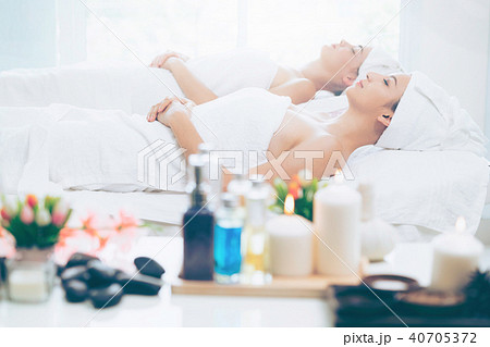 Relaxed young woman lying on spa bed for massage. 40705372