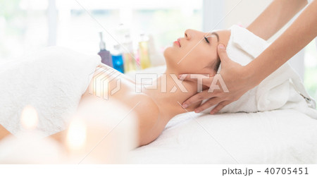 Relaxed woman gets facial and head massage in spa. Relaxed woman gets facial and head massage in spa. 40705451