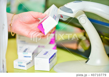 Pharmacist scanning barcode of medicine drug Pharmacist scanning barcode of medicine drug 40710779
