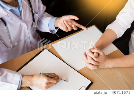 patient listening intently to a male doctor explaining patient s 40711675