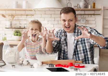 Father and daughter having fun while baking Father and daughter having fun while baking 40714645