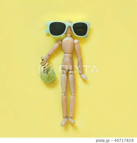 Concept heat summer. Wooden doll with fresh drink. 40717829