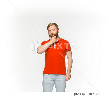 Closeup of young man's body in empty red t-shirt isolated on white background. Mock up for disign Closeup of young man's body in empty red t-shirt isolated on white background. Mock up for disign 40717835