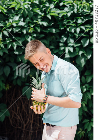 cheerful emotional guy holding a pineapple. 40718227