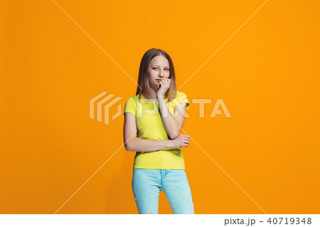 Beautiful teen girl looking suprised and bewildered isolated on orange Beautiful teen girl looking suprised and bewildered isolated on orange 40719348
