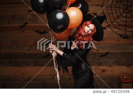 Halloween Witch Concept - Beautiful caucasian woman in witch costumes celebrating Halloween posing Halloween Witch Concept - Beautiful caucasian woman in witch costumes celebrating Halloween posing 40720306