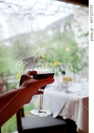 A glass of wine in hand 40720745