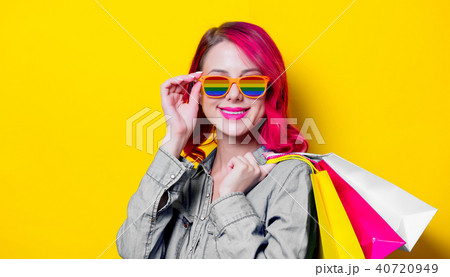 girl in rainbow sunglasses holding a bags girl in rainbow sunglasses holding a bags 40720949